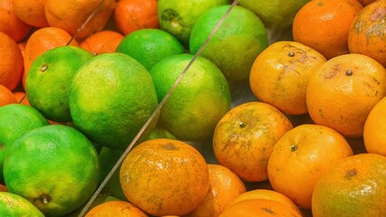 A vibrant close-up showcasing the freshness of green and orange tangerines