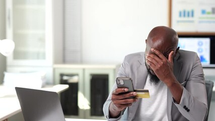 Frustrated businessman experiencing difficulty completing online payment, struggling with credit card transaction while using smartphone in office environment