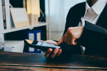 Professional Business Person Using Smartphone in Modern Office Setting, business concept