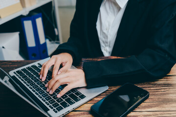 Professional Hands Typing on Laptop in Office Setting, business concept