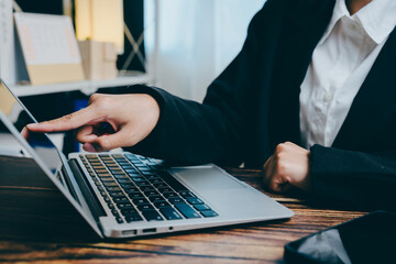 Person Using Laptop Touchscreen in Modern Workspace Environment, business concept