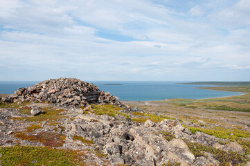 Old abandoned military stone pillbox on the shore of the Barents Sea. Rybachy Peninsula, Murmansk region, Northern Russia