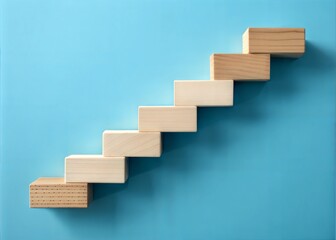 Fototapeta premium Wooden Steps Representing Progress Against a Light Blue Background