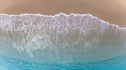 Tropical Beach with the soft wave water of the sea on the sandy beach background as texture with splashes