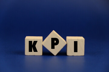 letters of the alphabet with KPI words. on wooden block isolated on dark background. Business management concept. 