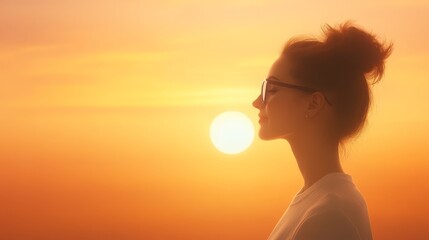 Woman in sunglasses shields her eyes from the bright golden sunlight of the summer sun