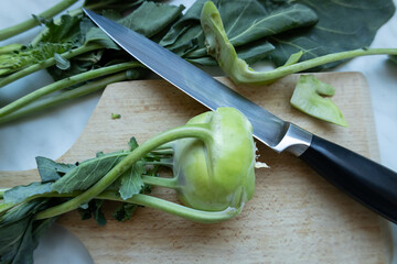 Close-up of fresh kohlrabi on a cutting board with a knife.