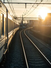 Obraz premium Charming Railway Track Curving Towards a Vibrant Sunset in a Serene Environment : Generative AI