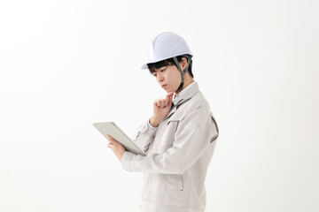 タブレットを持つ作業服の男性