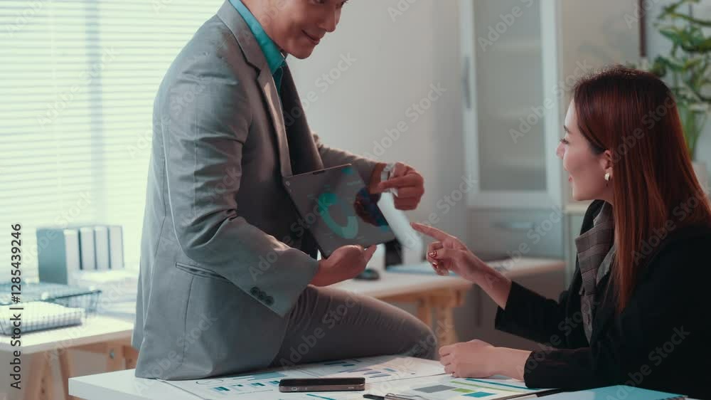 Fototapete financial analysts examining data charts on tablet, working closely in modern office environment, di