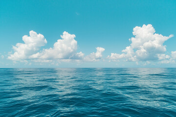Obraz premium calm ocean with clear blue sky and fluffy clouds creates serene scene