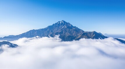Fototapeta premium Mountain Top with Serene Clouds on Crystal-Clear Blue Sky