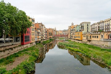 Fototapeta premium Girona Spain - 25 April 2024 - Colourful houses along the Onyar River in Girona