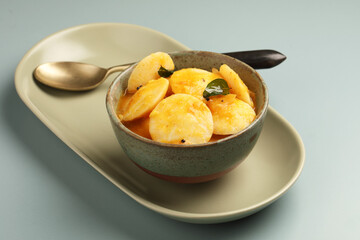 Idli Sambar, South Indian Dish served in ceramic bowl
