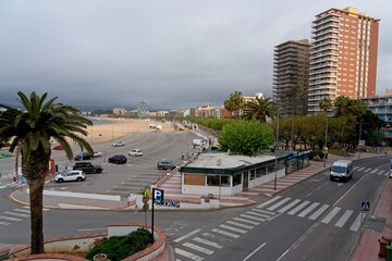 Palamos Spain - 27 April 2024 - View of downtown Palamos in early morning with apartment buildings and a beautiful beach