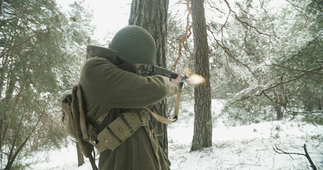 Naklejka premium Usa Soldier With Old Thompson Sub-machine Gun. Close-up View Detail On Thompson Sub-machine Gun In Hands Of Re-enactor Dressed As American Infantry Soldier. Usa Army Soldiers Of World War Ii