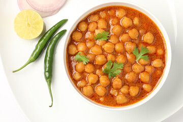 Famous Indian Dish Chole Puri in a white ceramic cutlery on white background 