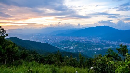Obraz premium Stunning panoramic view of a sunset over a lush green mountain landscape with a city below : Generative AI