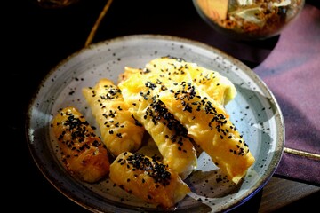 Delicious pastry with homemade cheese, black cumin and sesame seeds. Ramadan iftar table. Traditional Turkish cuisine flavors. Pastries. Close-up.