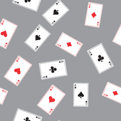 Seamless pattern with playing cards. Playing cards scattered on the table. Suits of playing cards - Spades, Hearts, Clubs, Diamonds. Texture background. Wallpaper template.