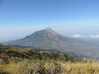 beautiful view of Merbabu mountain with clear and slightly cloudy sky