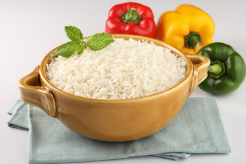 Rice in ceramic cutlery on white background