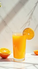 Glass of orange juice with a slice of orange on the side