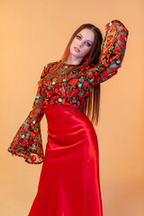 An Elegant Model Posing in a Stunning and Stylish Floral Dress Set Against a Warm Background