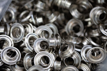 A Detailed CloseUp of Metallic Grommets and Eyelets for Various Crafting Projects and Activities