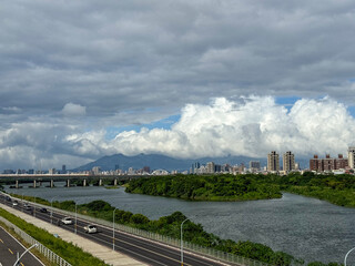Fototapeta premium Dahan River and Taiwan High-Speed Rail with Taipei Skyline and Yangmingshan in the Distance