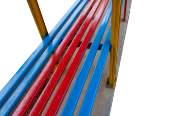 Colorful Metal Bench with Red, Blue, and Yellow Bars in Outdoor Public Park