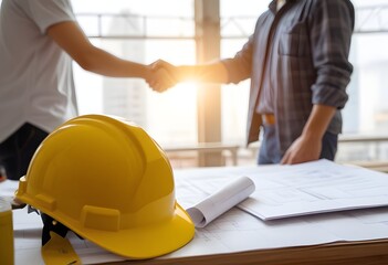 Two construction workers shaking hands on a construction site
