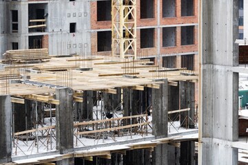 Construction site background. Hoisting cranes and new multi-storey buildings. Industrial background.