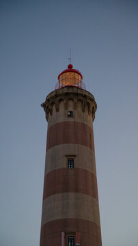 Farol do Barra aveiro lighthouse in Aveiro district, standing tall on a cloudy day