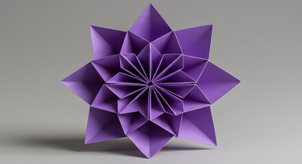 Exquisite origami star flower created from purple paper with intricate folds