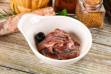 Canned anchovy with oil in the bowl