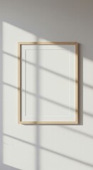 Minimalist Elegance: Blank Frame on a Sunlit Wall