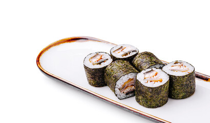 Sushi rolls prepared on a white plate in a minimalist setting