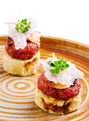 Delicious gourmet tartare served on crispy crust with garnishes