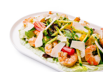 Colorful salad with shrimp, vegetables, and cheese on a plate