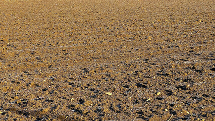 View of fields in early spring after harvest, brown plowed fields