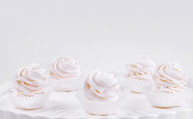 Elegant cupcakes on white pedestal stand