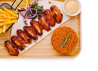 Savory grilled chicken wings served with rice and fries