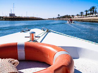 Boat sailing along canal and leaving marina Lagos Portugal. Boat trip to sea for fishing,...