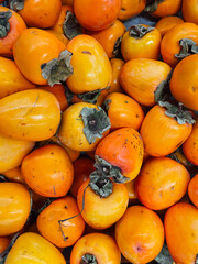 lots of ripe orange persimmons for eating fruit
