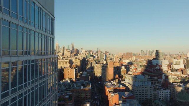 Aerial view capturing Nomo Soho Hotel rooms exterior and New York City skyline, revealing dense urban architecture and intricate street grid from high angle perspective