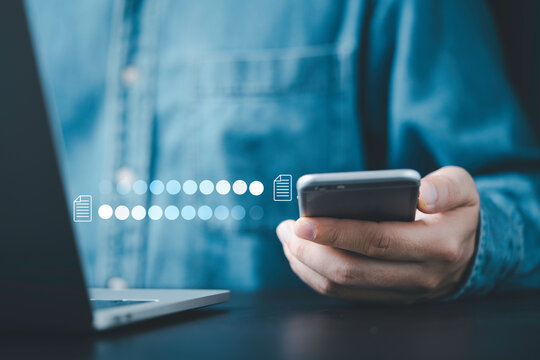Businessman using smartphone and laptop computer to transfer document information data for backup data file of digital technology concept.