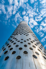 Abstract View of Modern Architectural Tower Against Blue Sky with Circular Patterns : Generative AI