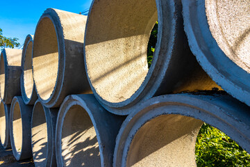 Large sewage cement pipes at the road construction site Thailand.