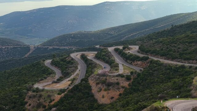 Aerial view of a winding road with numerous twists and turns meandering through the mountainous terrain of the Taygetus Mountains in the Peloponnese, Greece.